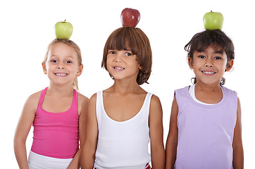 Image showing Portrait, apple or happy kids in studio with nutrition, wellness or healthy diet isolated on white background. Head, balance or group of a young children with natural fruits for vitamin c with smile