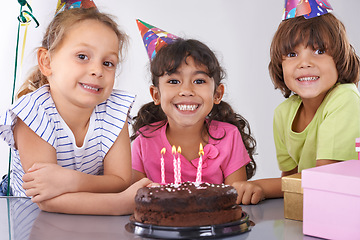 Image showing Friends, kids and birthday cake, party and candles with happy people for celebration, youth and dessert. Special day, together in festive mood and children smile for social event with chocolate
