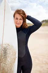 Image showing Surfer, woman and portrait on beach with surfboard, vacation and adventure for fitness and travel. Ocean, waves for surfing and seaside holiday in Hawaii, nature and tourism with extreme sports