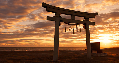 Image showing Torii gate, sunset sky in Japan with clouds, zen and spiritual history on travel adventure. Shinto architecture, Asian culture and calm nature on Japanese landscape with sacred monument at shrine.