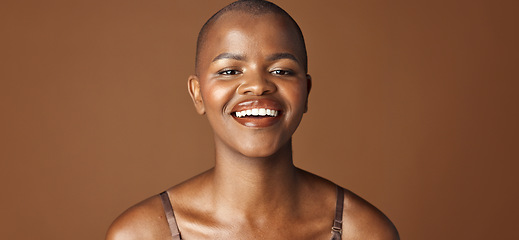 Image showing Face, beauty and smile with happy black woman in studio isolated on brown background for wellness. Portrait, skincare and aesthetic for foundation cosmetics or dermatology with a natural bald person