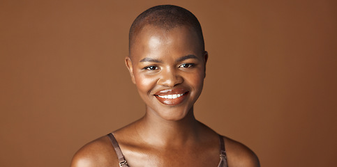 Image showing Face, beauty and smile with happy black woman in studio isolated on brown background for wellness. Portrait, skincare and aesthetic for foundation cosmetics or dermatology with a natural bald person