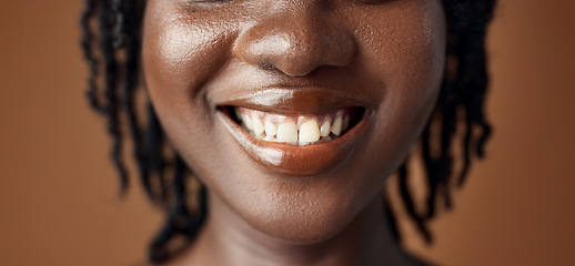 Image showing Woman, teeth closeup or smile for dental care, oral hygiene or healthy wellness on brown background. Mouth, lips or face of a happy model in studio for tooth whitening, beauty or dentist treatment