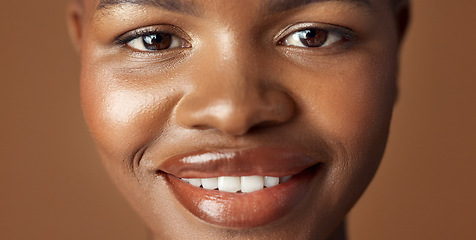 Image showing Face of black woman, natural beauty or glow for wellness, cosmetics or healthy skin in studio. Dermatology, closeup or happy African girl model with smile or skincare results on brown background