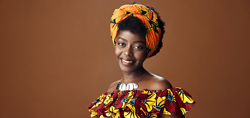 Image showing Wrap, fashion or face of happy black woman in studio on a brown background for trendy style. Smile, African or model with confidence, pride or afro posing in culture, clothes or traditional outfit