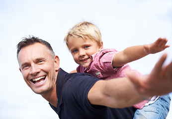 Image showing Father, son and happy with airplane game by outdoor, freedom and fun with love bonding in city. Man, child or playing fantasy flying by arms in air, childhood and trust together in nature outside