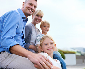 Image showing Happy, parents and children outdoor in portrait at house in summer with love, freedom and together on blue sky. Family, care and support kids with smile in backyard at home with mother and father