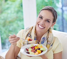 Image showing Healthy food, woman in portrait with fruit salad and diet, organic product and relax on sofa with smile for weight loss. Vegan meal, gut health and wellness, eating for nutrition with vitamins