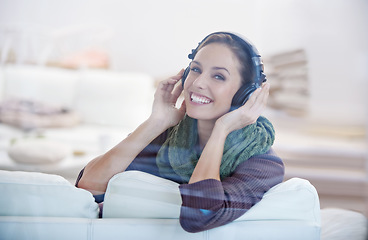 Image showing Happy, portrait and woman with music headphones on a sofa streaming, listening or chilling at home. Face, smile and female person in a living room with earphones for radio, audio or playlist track