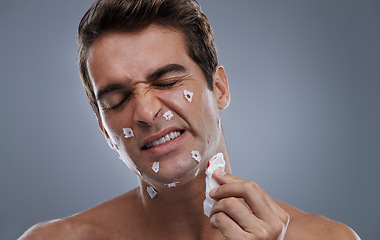 Image showing Man, face and shave cuts in studio for hair removal hygiene or injury with blood, tissue or maintenance. Male person, grey background and dermatology with beard or clean health, wellness or mockup