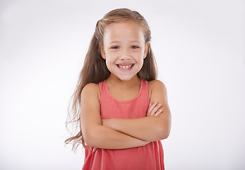 Image showing Child, smile and portrait or confidence with arms crossed in studio for good mood, happy or relax. Female person, girl model and face or white background as mockup space or proud, peace or positivity