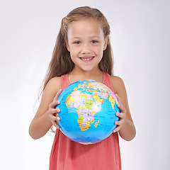 Image showing Child, portrait and globe in studio with world, planets and city for education, geography and happy. Student, girl kid and travel map with smile for earth day support or lesson on white background