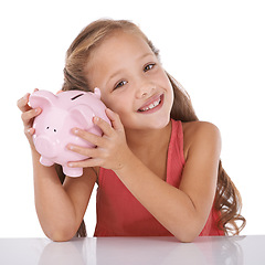 Image showing Girl child, piggy bank and listen for money, studio and check with pride for savings by white background. Confused kid, portrait and animal toys for coins, cash or learning for financial education