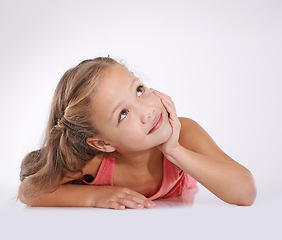 Image showing Thinking, kid and girl with ideas or decision and contemplation on white studio background. Model, mockup space and child development with daydreaming, wonder or planning with choice, happy or ponder