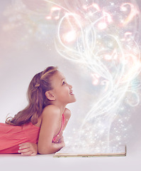 Image showing Child, book and magic fantasy or light for storytelling creativity inspiration, surreal or imagination. Female person, kid and whimsical or white background in studio mystic, music or mockup