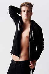 Image showing Portrait, hoodie and man with body, muscular and confident guy on a white studio background. Person, fashion and model with self care, aesthetic and clothing with bodybuilder, masculine and attitude