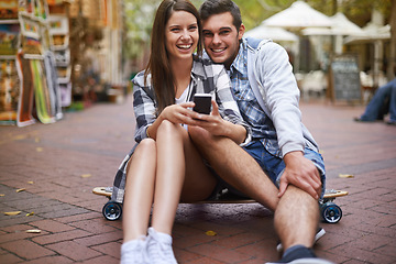 Image showing Couple, sitting on skateboard and portrait with phone, happy and social media with partner, scrolling and relationship. Cape town, fun and hobby with boyfriend and girlfriend in street, love or date