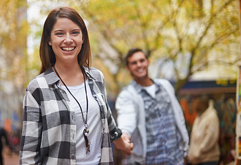 Image showing Portrait woman, journey and happy couple holding hands, lead partner and explore new city on holiday, vacation or walk. Love, abroad and bonding man, girlfriend or people smile together on commute