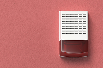 Image showing Alarm siren on red wall