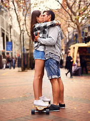 Image showing Couple, skateboarding and kissing in city, in love and excited to learn together and romantic relationship. Cape town, fun and hobby with boyfriend and girlfriend in street, helping and dating