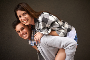 Image showing Smile, hug and portrait of couple piggyback ride, bond and having playful fun isolated on grey background. Support, embrace and young silly man, woman or people happy for funny game with partner