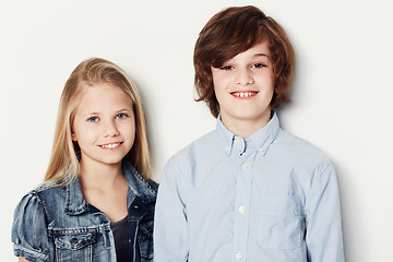 Image showing Happy, portrait and children or siblings on a white background for fashion, style and clothes. Smile, cute and a boy, girl and kids in a studio for fashionable youth and clothing on a backdrop