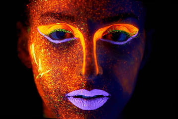 Image showing Portrait, art and beauty with neon woman on black background for makeup, glitter or colorful glow. Face, fantasy and creative with confident young person in the dark for psychedelic or techno paint