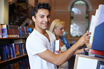 Image showing Portrait, book or student in a library to search at university, college or school campus for education. Bookshelf, learning or happy man with scholarship studying knowledge, research and information