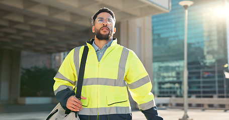 Image showing Engineer man, walking and street in city, thinking and ideas on travel to work, bag and outdoor. Technician, architect or contractor on urban road or sidewalk in metro cbd for infrastructure job