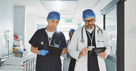 Image showing Teamwork, talking and doctors with a tablet at a hospital for health advice or surgery communication. Help, clinic and medical employees speaking with technology, planning and schedule for nursing