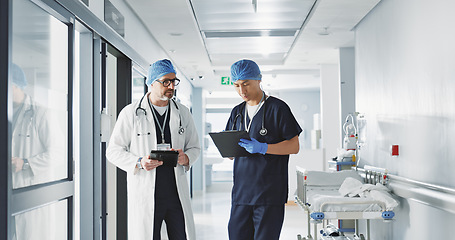 Image showing Healthcare, talking and doctors with a tablet at a hospital for health advice or surgery communication. Help, clinic and medical employees speaking with technology, planning and schedule for nursing