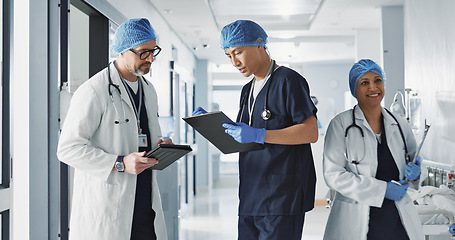 Image showing Teamwork, talking and doctors with a tablet at a hospital for health advice or surgery communication. Help, clinic and medical employees speaking with technology, planning and schedule for nursing