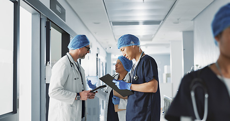 Image showing Teamwork, talking and doctors with a tablet at a hospital for health advice or surgery communication. Help, clinic and medical employees speaking with technology, planning and schedule for nursing