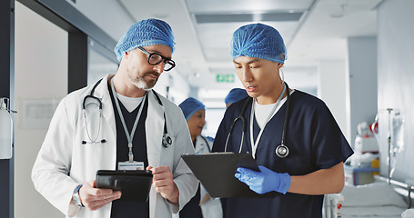 Image showing Teamwork, talking and doctors with a tablet at a hospital for health advice or surgery communication. Help, clinic and medical employees speaking with technology, planning and schedule for nursing