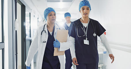 Image showing Doctors, nurses and women walking, talking and planning healthcare, clinic management and workflow schedule. Medical worker, surgeon and mentor support, hospital teamwork and folder or patient charts