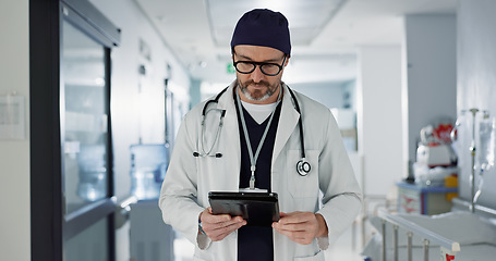 Image showing Hospital, doctor and man with a tablet, typing and healthcare with email, consultant and website info. Mature person, employee and medical professional with technology, search internet and surgeon