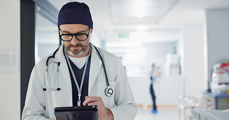 Image showing Hospital, doctor and man with a tablet, typing and healthcare with email, consultant and website info. Mature person, employee and medical professional with technology, search internet and surgeon