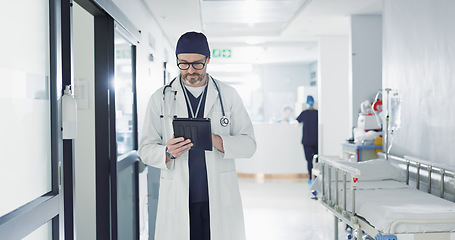 Image showing Hospital, doctor and man with a tablet, typing and healthcare with email, consultant and website info. Mature person, employee and medical professional with technology, search internet and surgeon