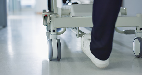 Image showing Healthcare, doctor and push bed in hospital for surgery, emergency or medical problem in corridor. Medicine, professional and nurse feet with stretcher for wellness, service and risk in clinic or job