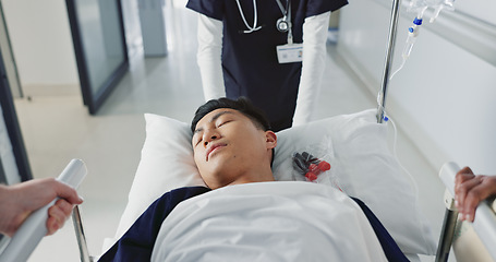 Image showing Asian man, patient and push bed in hospital for surgery, emergency or medical problem in corridor. Medicine, professional or person with stretcher for wellness, service and risk in clinic or job