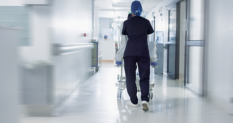 Image showing Patient, bed and nurse walking in hospital, hallway or corridor to surgery, operation room or ER healthcare service. Doctor, moving and pushing person in clinic to ICU, bedroom or walk with support