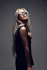 Image showing Portrait, woman and glasses in studio with fashion, style and trendy prescription with positive by gray background. Model, confident and eyecare on face with wellness, blonde and elegant aesthetic