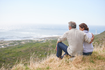 Image showing Old couple, hug and sitting on a mountain with love in marriage, retirement or holiday mockup space. Summer, vacation and man and woman embrace with support, care or trust with view of sea or ocean