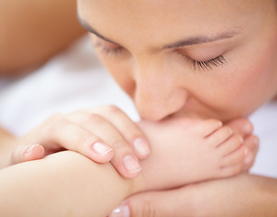 Image showing Mom, baby and kiss feet of child for love, care and relax in nursery room at home. Face, mother and closeup of foot of young kid for newborn development, healthy childhood growth or affection of bond