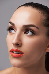 Image showing Face, beauty and woman is thinking with makeup, cosmetics and orange lipstick on grey background. Inspiration, insight and dream with model in studio, lashes and glamour with elegance and skin