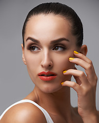 Image showing Face, beauty and manicure nails with woman in studio isolated on gray background for luxury cosmetology. Thinking, makeup and lipstick with confident young model at salon for aesthetic cosmetics