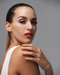 Image showing Woman in portrait, beauty and hand with manicure, makeup and yellow nail polish, skin and cosmetics on grey background. Lipstick, color nails and model with confidence in studio and glamour or glow