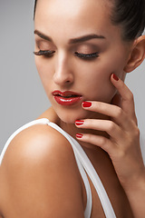 Image showing Makeup, woman for beauty and manicure in studio, nail polish and lashes with skin and cosmetics on grey background. Red lipstick, color nails and glamour with mascara for confidence and elegance
