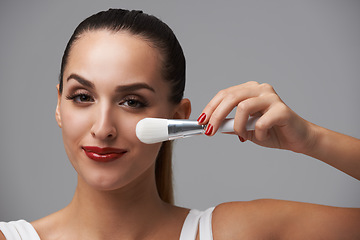 Image showing Woman, face and brush for makeup, beauty and red lipstick with manicure and cosmetic tools on grey background. Portrait, equipment with color nails and lips, foundation or powder with smile in studio
