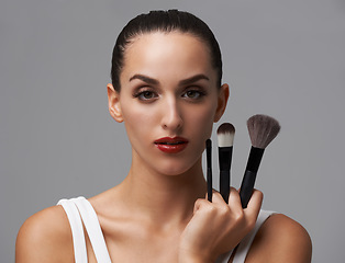 Image showing Woman, brush for makeup and beauty in portrait, cosmetic tools with cosmetology and skin on grey background. Red lipstick, confidence and face of model in studio, foundation or powder with equipment